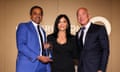 Conservation International chief executive officer M Sanjayan, left, presents Jeff Bezos and Lauren Sánchez with the global visionary award.