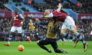 Alan Hutton of Aston Villa fouls Theo Walcott of Arsenal for a penalty
