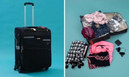 A black suitcase with clothes inside.