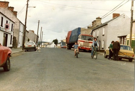John and Tom Doyle cycling on Main Street, Coolaney, County Sligo.