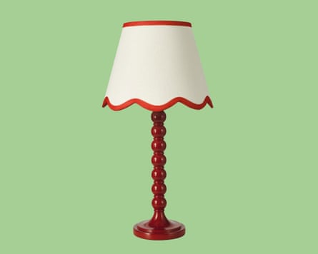 cream lampshade with red edging on a table lamp