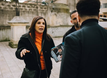 Nora Preziosi with flyers talking to a person