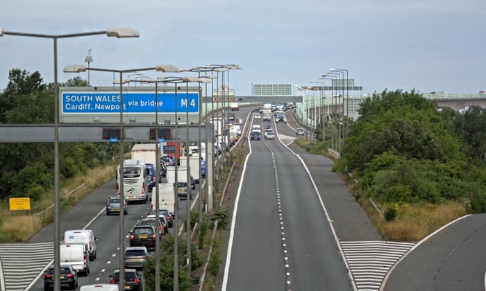 Police escort vehicles across the Prince of Wales Bridge, which runs between England and Wales, during the morning rush hour as drivers hold a go-slow protest on the M4.
