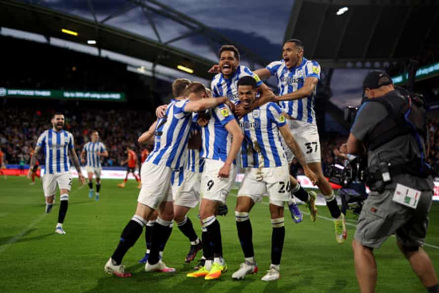 Jordan Rhodes of Huddersfield celebrates with his teammates after opening the scoring.