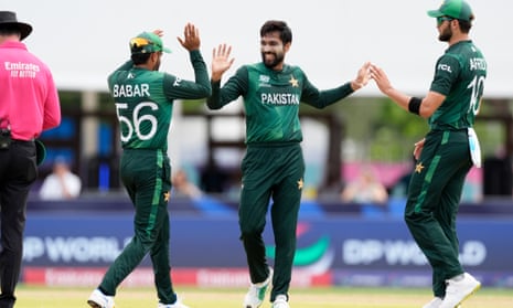 Mohammad Amir, center, celebrates with teammates the wicket of Ireland's George Dockrell.