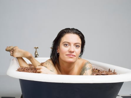 Jack Monroe in a roll-top bath filled with copper coins