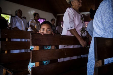 People attend a church service on Sunday morning in Kioa