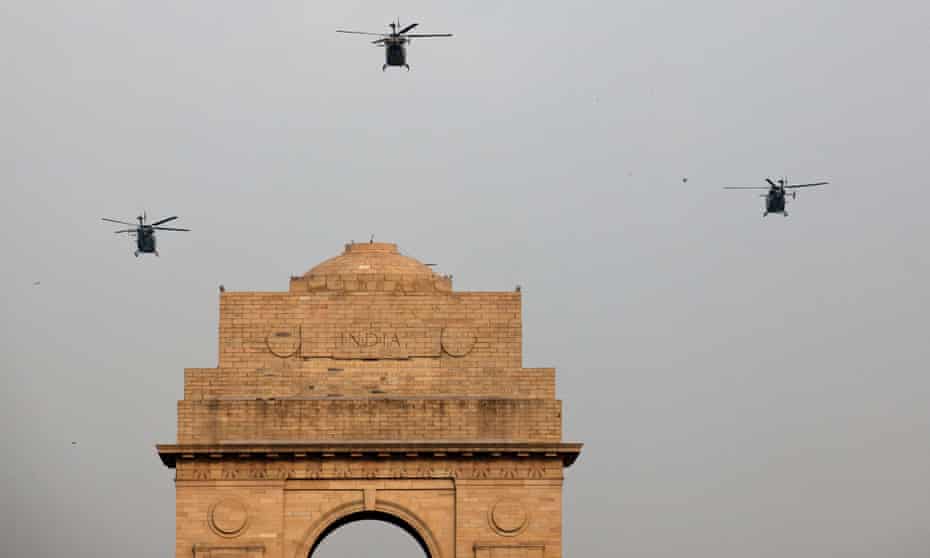 Helicopters fly near the India Gate war memorial