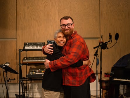 pair hug in front of keyboards