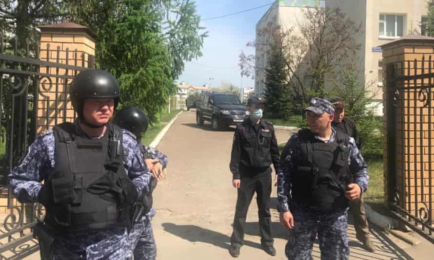 Security forces take up positions outside the school