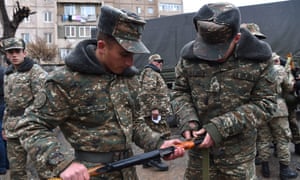 Armenian volunteers receive uniforms and weapons to join the self-defense army of Nagorno-Karabakh in Yerevan, Armenia.