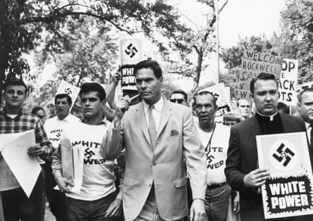 Rockwell, pipe in hand, leads a group of his supporters in 1967.