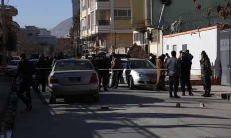 Afghan security force members inspect the site of the attack on two female judges in Kabul.