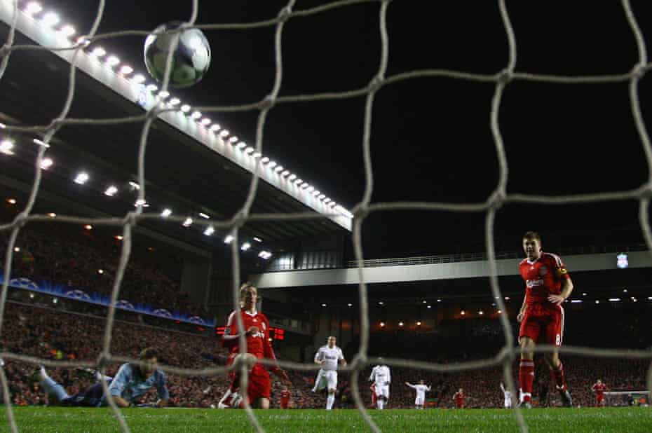 Fernando Torres scores against Real Madrid, with Steven Gerrard watching on, in 2009