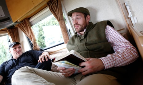 Tyson Fury, with his father, John, reads from the Bible in a caravan at his home near Ormskirk, Lancashire. 