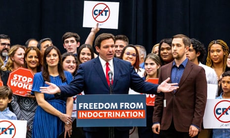 DeSantis at podium with sign reading freedom from indoctrination
