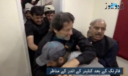 Imran Khan is helped after he was shot in Wazirabad, Pakistan, 3 November.