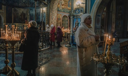 Worshipers lighting candles at the St. Michael's Golden-Domed Monastery.