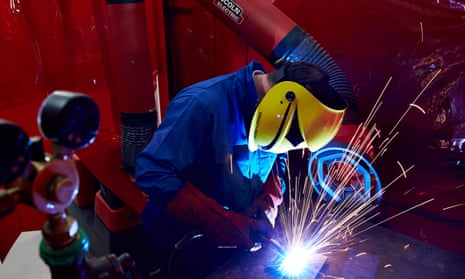 A welder works in a factory