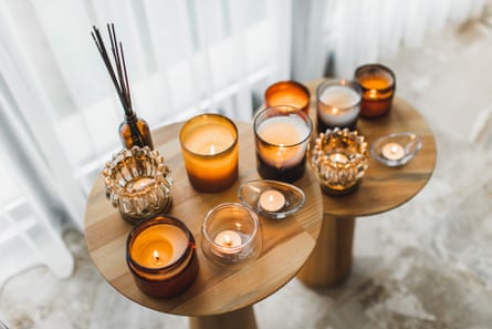 Scented candles in different candlelights on a wooden table