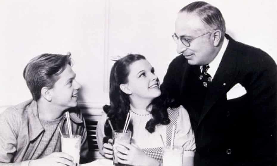 Actors Mickey Rooney and Judy Garland with Louis B Mayer. Mayer insisted his young protege sit on his lap.
