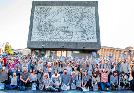 Protesters wearing striped sweaters in honour of Picasso demonstrate in front of the Fishermen mural in 2019.