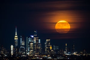 The moon rises over Manhattan in New York City, United States