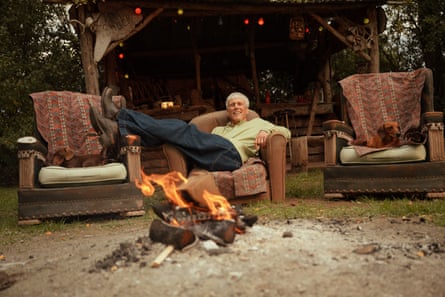 Bez lounges on a chair in front of a fire pit.