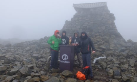 The students and Box Steam brewery barman enjoy a crafty pint at the 1,344-metre summit of Ben Nevis.