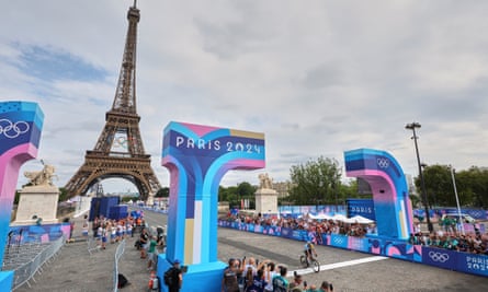 Remco Evenepoel crosses the line with the Eiffel Tower behind him after overcoming a late puncture.