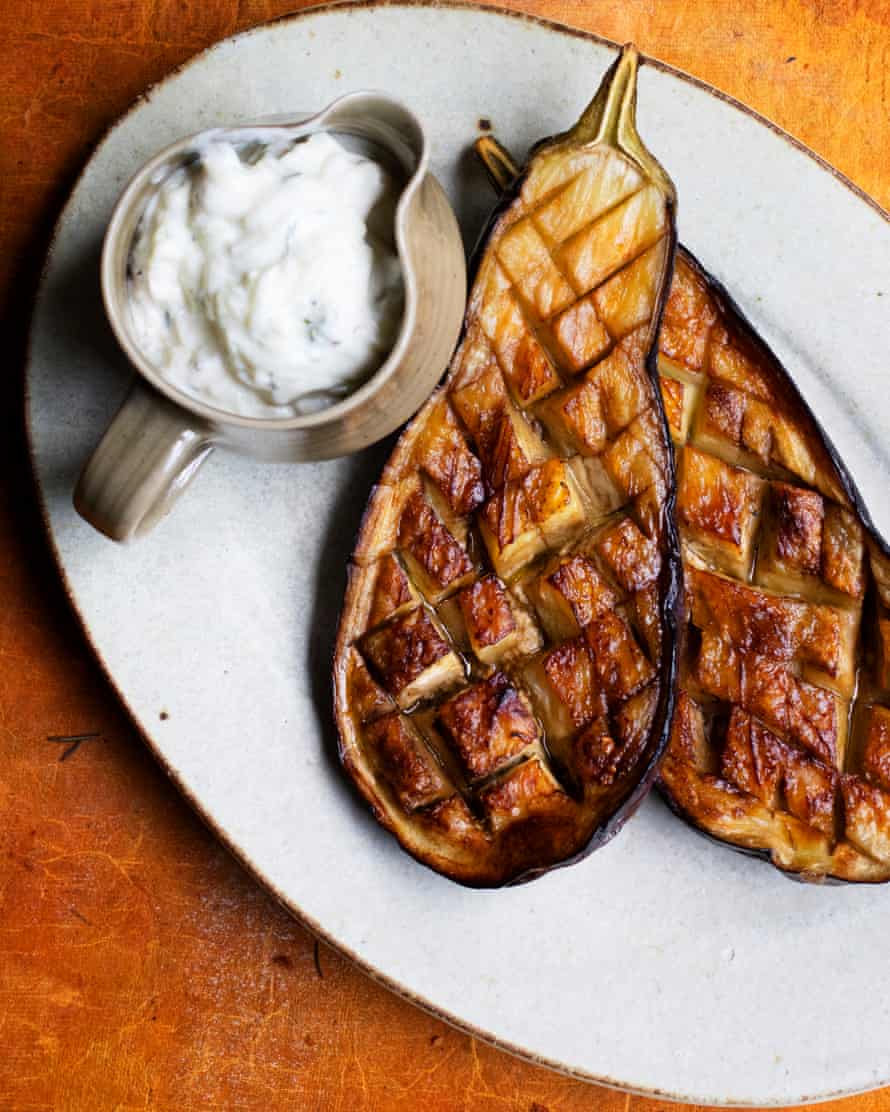 ‘The crisscross of slashes on the cut side is the way to get them cooked right through’: baked aubergines with cucumber and basil sauce.