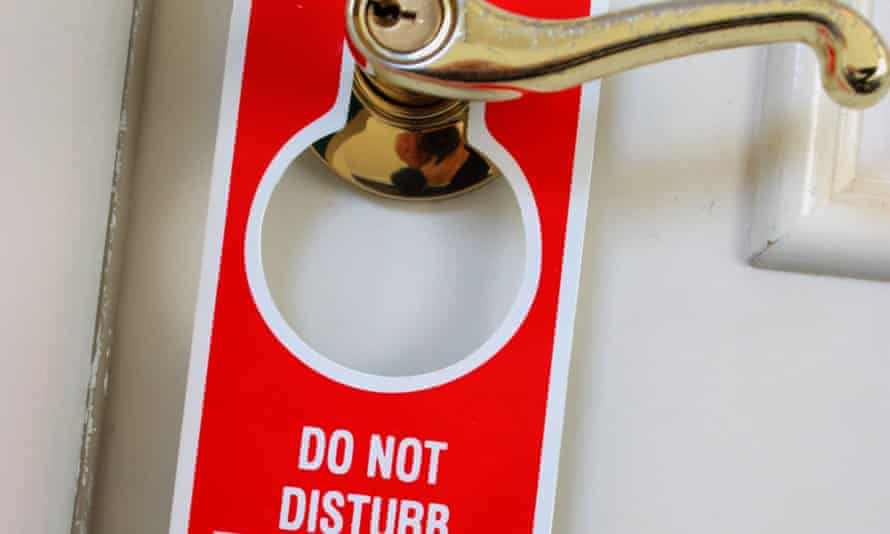 Close up of a Do not disturb notice hanging from a hotel room door