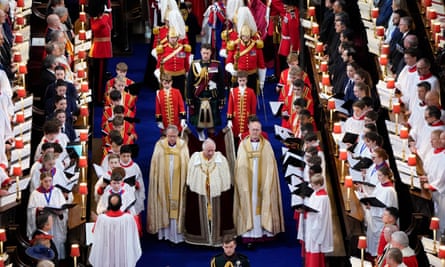 King Charles III arrives for the coronation ceremony flanked by clergymen, pages and choristers
