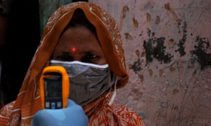 A woman has her temperature taken during mass screening in Mumbai
