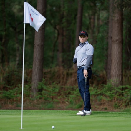 Matthew Gamble, a 24-year-old golfer with one arm from Royal Mid-Surrey golf club, who plays the sport ‘back-hand’, putts on the 14th hole