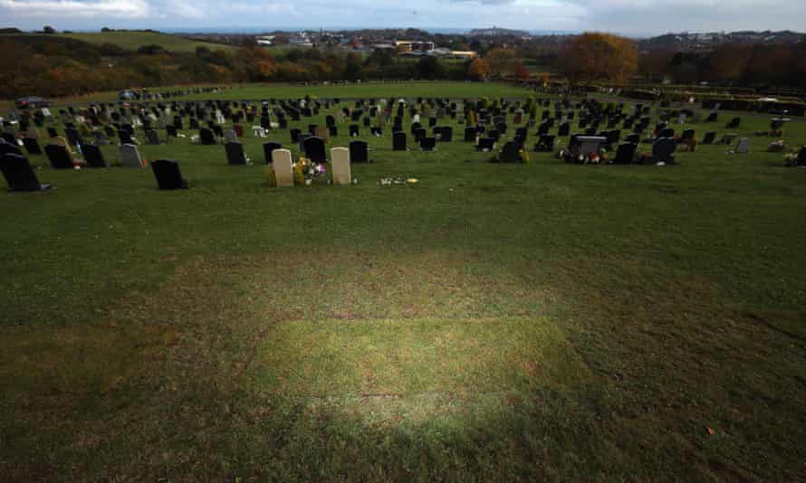 Plain turf is all that marks the grave of Jimmy Savile at Woodlands Cemetery in Scarborough, 2012.