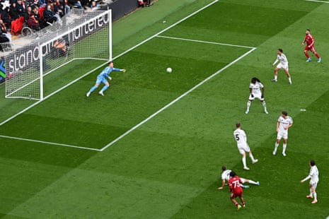 Rio Ngumoha of Liverpool scores his team's first goal past Bernd Leno.