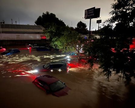 Cars partly submerged in flood waters