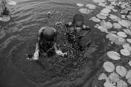 School children, aged 8 and 9, wash in a river in Nampula province