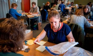 Swedish election officials count parliamentary ballots.