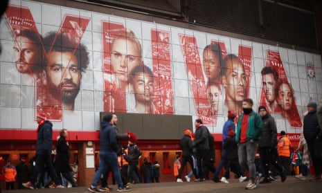 Fans walk past a graphic at Anfield displaying Mohamed Salah, Virgil van Dijk and Andy Robertson – three signings from Michael Edwards’ first spell.