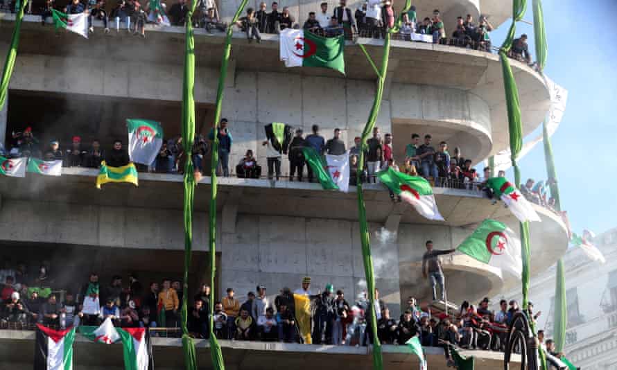 Protesters gather on a building in Algiers