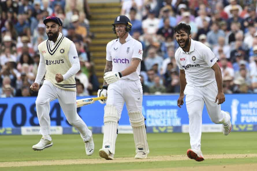 Shardul Thakur celebrates with Virat Kohli as Ben Stokes walks off.