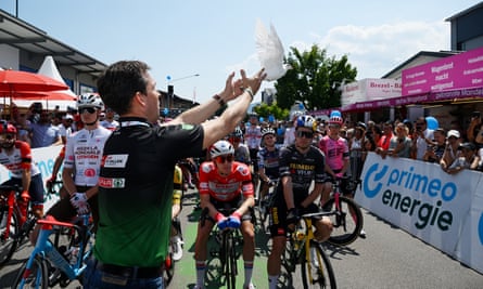 A dove is released by a staff member before the start of Saturday’s stage