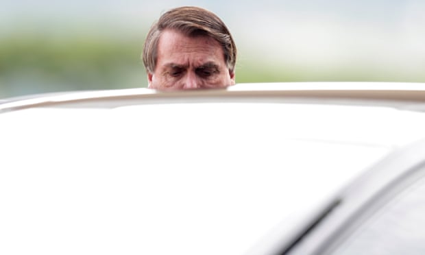 President Jair Bolsonaro speaks with supporters while he leaves Alvorada Palace in Brasilia on Tuesday.