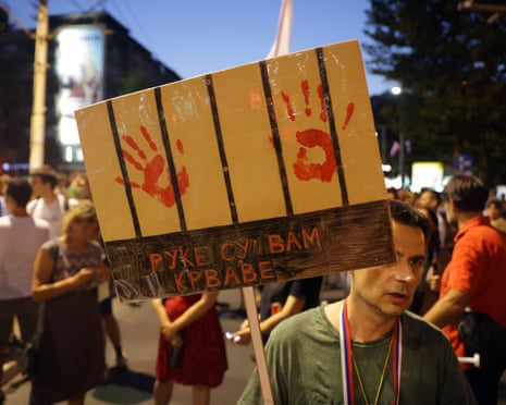 A protester holds a banner reading 'Your hands are bloodied' during an anti-government protest in Belgrade, Serbia.