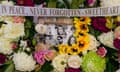 A floral tribute featuring photos of the victims in Saturday's knife attack 