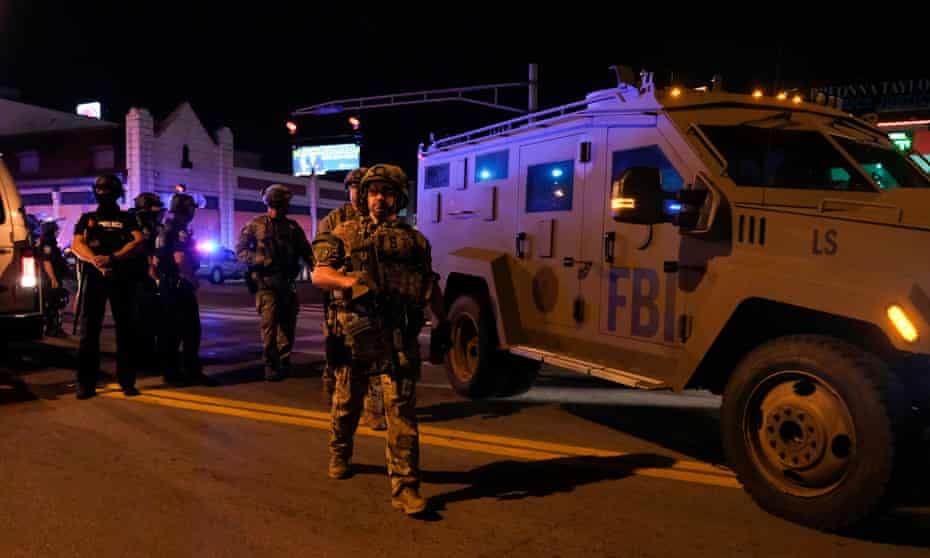 FBI agents patrol near the site where two police officers were shot in downtown Louisville, Kentucky, on September 23, 2020.
