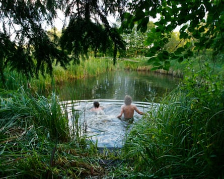 Egle (left) and Patrikas (right) swim in a pond during the midsummer summer solstice