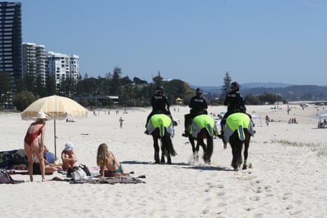 Police on horses are seen on Coolangatta beach.